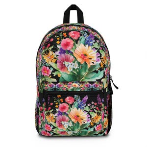 May include: Black backpack adorned with a colourful floral design. The pattern showcases a watercolour-style arrangement of pink, orange, yellow, and purple flowers on a black backdrop. The backpack has a black handle, zip, and side pocket.