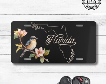 Placa de matrícula con el ave y la flor del estado de Florida / Matrícula con el sinsonte norteño y la flor de naranjo