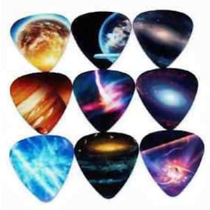 May include: Set of 12 guitar picks with colorful space-themed designs. The picks feature images of planets, galaxies, and nebulas.