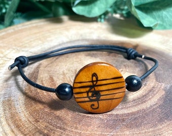 Handburned, Music note wooden bead boho/hippie bracelet with a treble clef handburned on the coin style bead with adjustable leather cord.