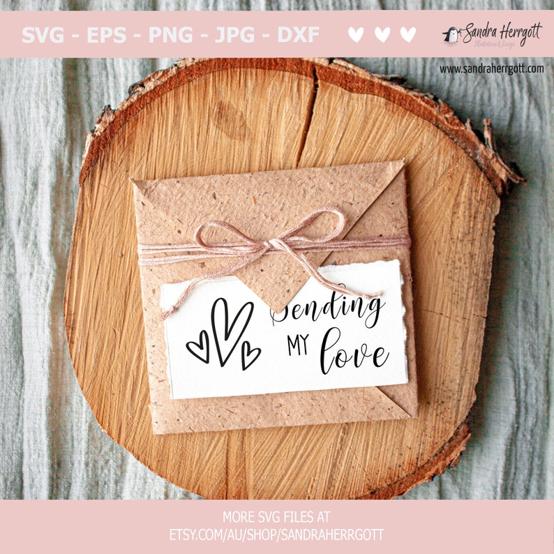 May include: A brown envelope with a twine bow tied around it. The envelope is sitting on a wooden surface. A white card inside the envelope has the text "Sending my love" and three black hearts.