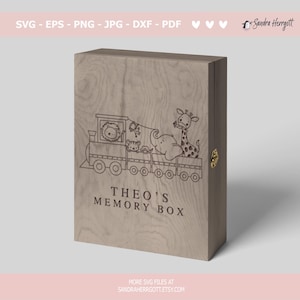 May include: A wooden memory box with a train illustration carrying a lion, tiger, elephant, and giraffe. The text "THEO'S MEMORY BOX" is below the train. The box has a gold-colored clasp and the text "SVG - EPS - PNG - JPG - DXF - PDF" at the top.
