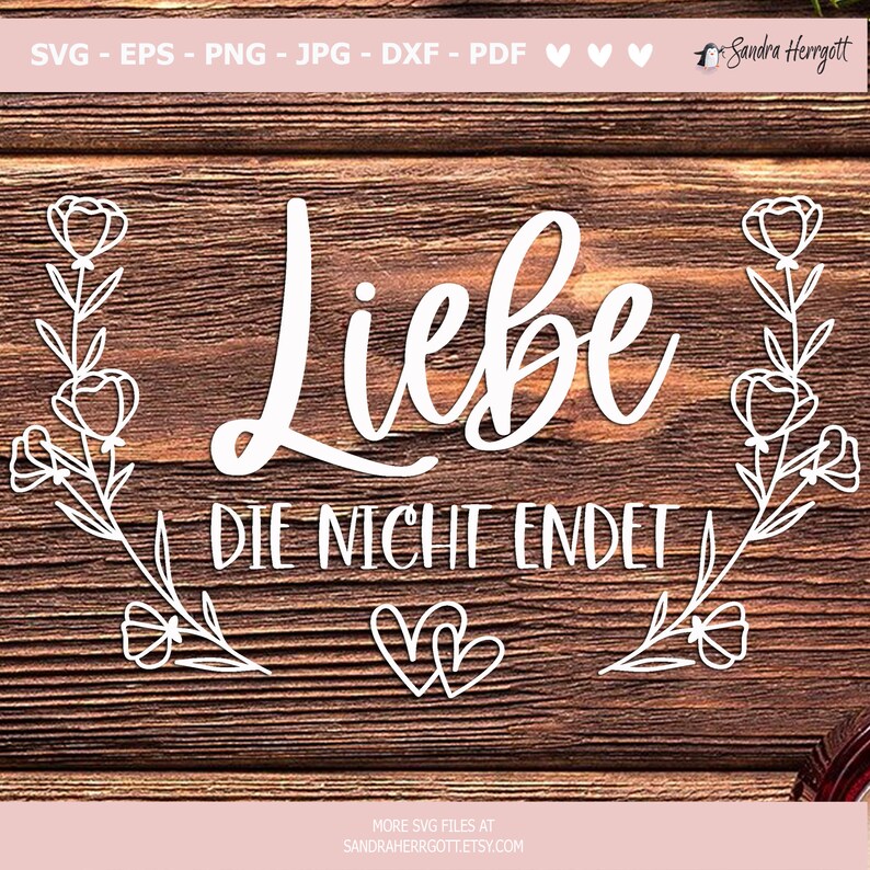 May include: White cut-out design on a wooden background. The word "Liebe" is in a cursive font, with "DIE NICHT ENDET" below it. Floral elements and hearts frame the text. The top of the image has file type options.