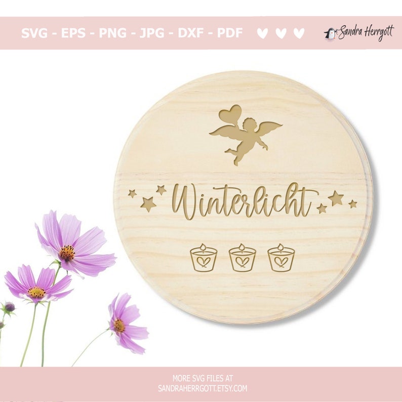 May include: A round, light-colored wooden plaque with the word "Winterlicht" engraved in a decorative font, along with an angel, stars, and candle illustrations. The plaque is surrounded by pink flowers.