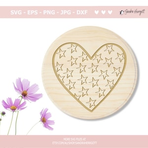 May include: A wooden heart-shaped plaque with a pattern of stars inside the heart. The plaque is light brown and the stars are a darker brown.