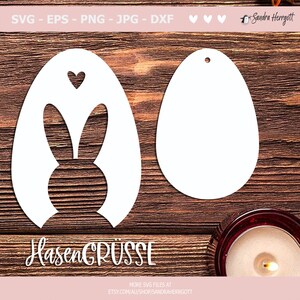 May include: Two white Easter egg-shaped cutouts. One features a bunny silhouette and a heart, the other is a blank egg shape. The text "HasenGR&Uuml;SSE" is at the bottom. The image includes file type information: SVG, EPS, PNG, JPG, and DXF.