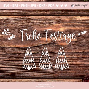 May include: White cut-out Christmas-themed SVG files on a wooden background. The design includes the German phrase "Frohe Festtage" and three Christmas trees. The image also includes the text "MORE SVG FILES AT SANDRAHERRGOTT.ETSY.COM".