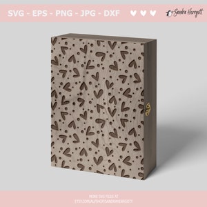 May include: A wooden box with a hinged lid, featuring a laser-cut design of repeating hearts and dots on the front. The box has a brass latch on the side.