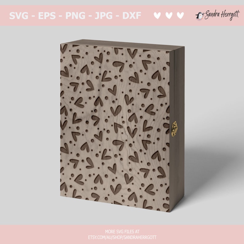 May include: A wooden box with a hinged lid, featuring a laser-cut design of repeating hearts and dots on the front. The box has a brass latch on the side.