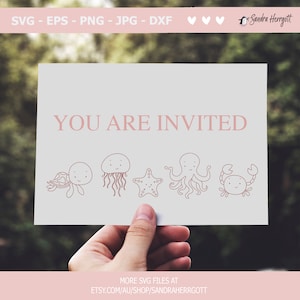 May include: A pink and white card with the text "YOU ARE INVITED" in pink.  The card features five illustrations of sea creatures: a turtle, a jellyfish, a starfish, an octopus, and a crab.  The card is being held by a hand.