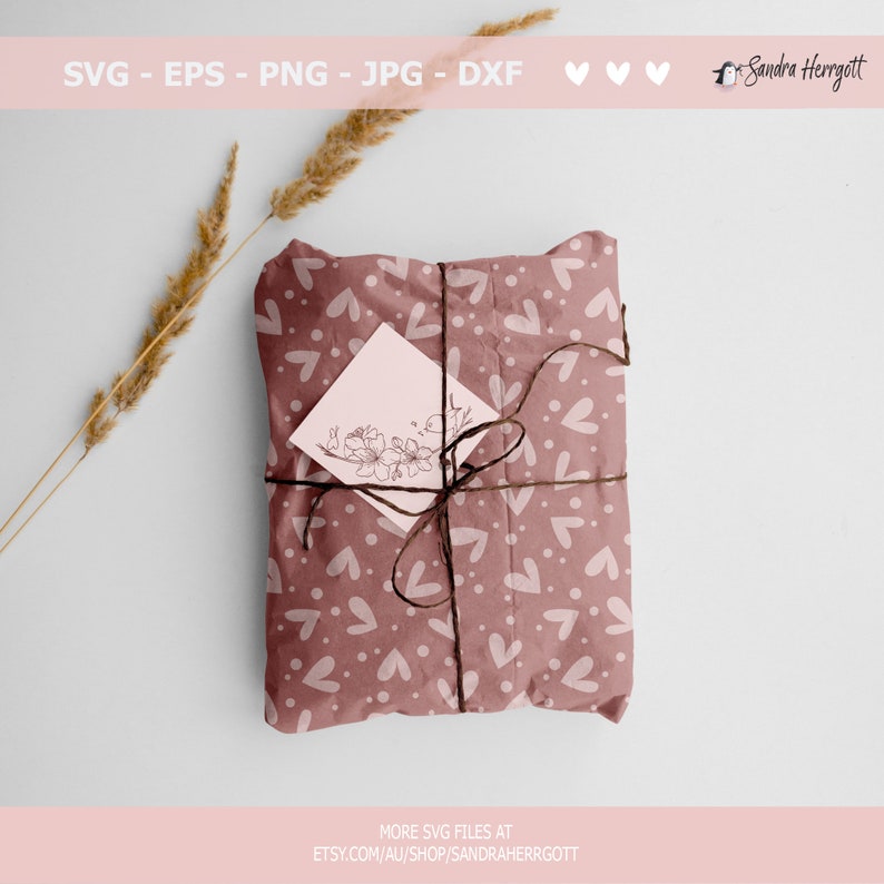 May include: A gift wrapped in brown paper with a white heart pattern. The paper is tied with twine and a small white card with a floral design is attached.