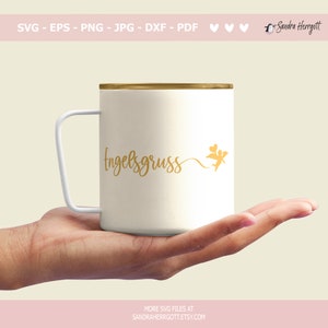 May include: A white mug with a gold rim and handle, featuring the gold script "Engelsgruss" and a small angel illustration. The mug is held in a hand. The image also includes the text "SVG - EPS - PNG - JPG - DXF - PDF" and "MORE SVG FILES AT SANDRAHERRGOTT.ETSY.COM".