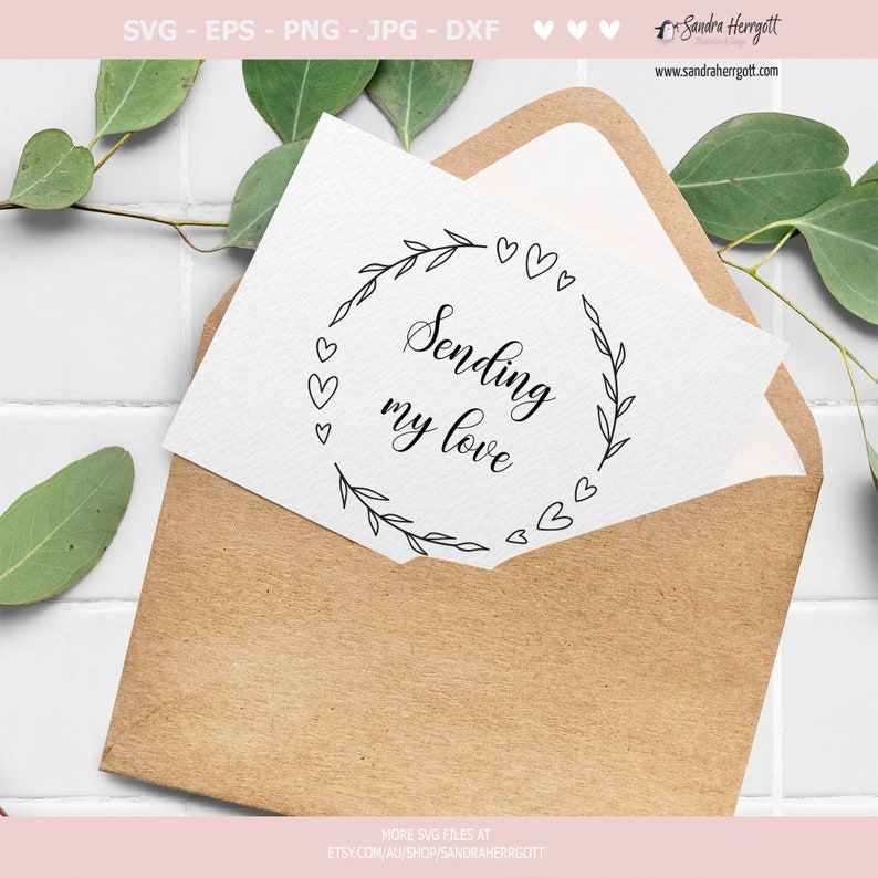May include: A white card with a black wreath of leaves and hearts surrounding the text "Sending my love".