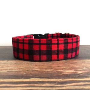 May include: Red and black checked dog collar with a black plastic buckle.