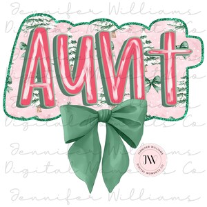 May include: A pink and green digital design with the word "AUNT" in large, pink, stylized letters. A green bow is below the word. The background is a pink and green pattern of trees and bows.
