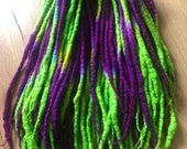 Vibrant purple & green wool dreadlock extensions