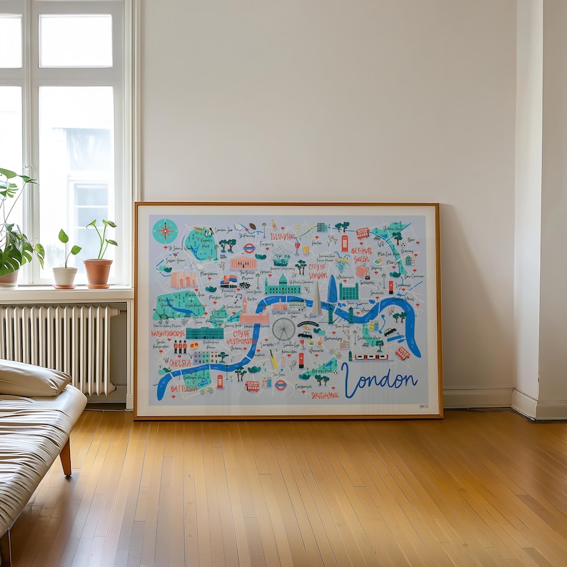 May include: A framed illustration of a map of London, England. The map is drawn in a colorful, whimsical style and features landmarks like Buckingham Palace, the London Eye, and the Houses of Parliament. The text "London" is written in a large, stylized font at the bottom of the map.