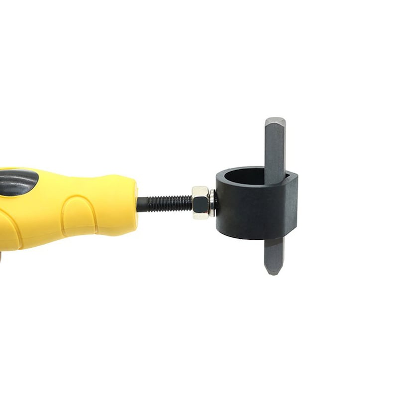 May include: A yellow handled tool with a black cylindrical component and a metal rod extending from it. The tool has a black cylindrical component with a metal rod extending from it. The tool is designed for a specific mechanical purpose.