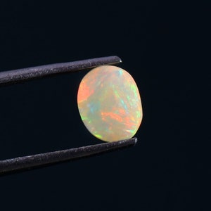 Natural Ethiopian Opal: 0.35 Carat Oval Fire Opal Crystal