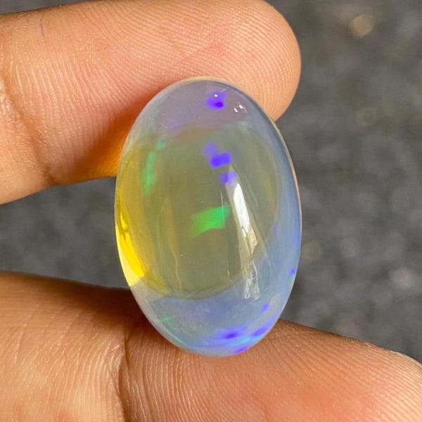 Ethiopian Opal Cabochon: Transparent Multi-Blue Fire Gemstone (23.55 Carat, 23x15x11 mm)