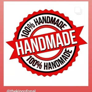 May include: A red and white circular emblem with the words "HANDMADE" and "100% HANDMADE" in a bold, sans-serif font. The emblem has a starburst design and is set against a white background.