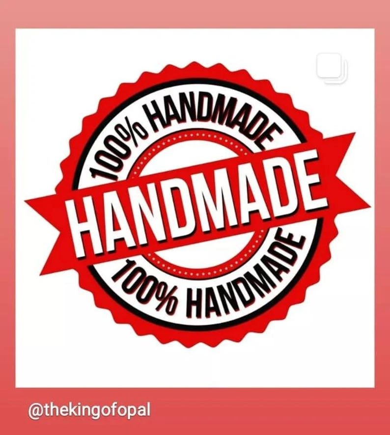 May include: A red and white circular emblem with the words "HANDMADE" and "100% HANDMADE" in a bold, sans-serif font. The emblem has a starburst design and is set against a white background.