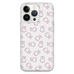 May include: A clear phone case with a white background and a repeating pattern of black bunny silhouettes with pink flowers. The case is designed for a phone with a triple lens camera system.