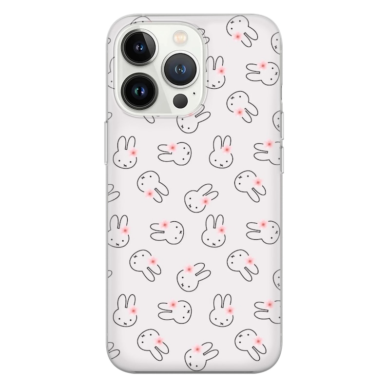 May include: A clear phone case with a white background and a repeating pattern of black bunny silhouettes with pink flowers. The case is designed for a phone with a triple lens camera system.