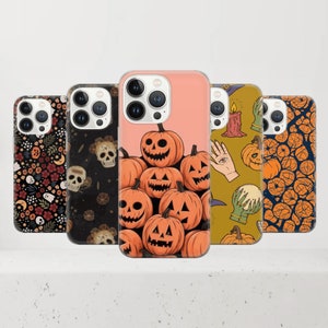May include: Five phone cases with Halloween-themed designs. The cases feature images of pumpkins, skulls, floral patterns, and mystical symbols. The cases are in various colors, including black, orange, and pink.