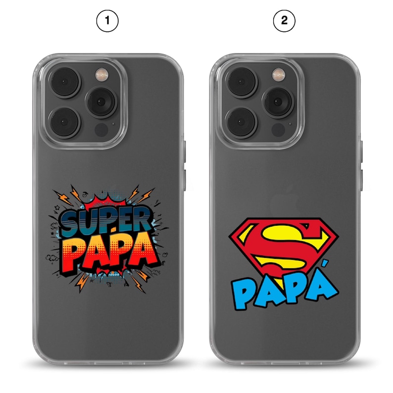 May include: Two clear phone cases for an iPhone Pro model. The first case features the text 'SUPER PAPA' in a comic book style with red, yellow, and blue colors. The second case displays a red and yellow shield logo above the blue text 'PAPA'.