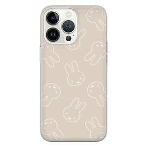 May include: A clear phone case with a beige background and a white bunny rabbit pattern. The case is designed for an iPhone.