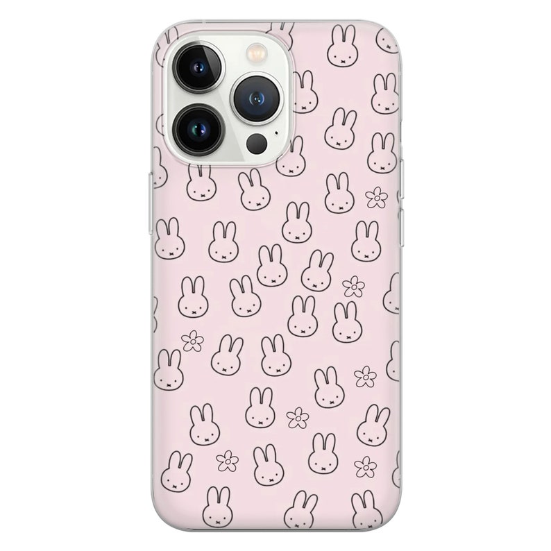 May include: A clear phone case with a pink background and a repeating pattern of black bunny rabbits and white flowers.