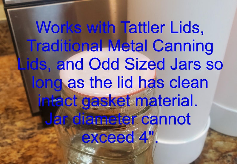 May include: A clear glass jar with a white lid. The lid has a red rubber gasket. The text on the image reads: "Works with Tattler Lids, Traditional Metal Canning Lids, and Odd Sized Jars so long as the lid has clean intact gasket material. Jar diameter cannot exceed 4"."