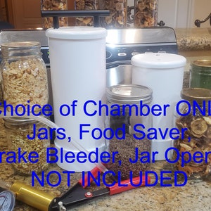 May include: A white food saver vacuum sealer with a choice of chambers, jars, and accessories. The image text reads "Choice of Chamber ONLY Jars, Food Saver Brake Bleeder, Jar Opener NOT INCLUDED".