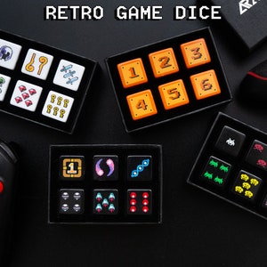 May include: A set of 10 retro game dice with various designs, including pixelated characters, numbers, and symbols. The dice are white with black details and are arranged in two rows on a black surface.