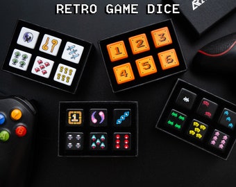 May include: A set of 10 retro game dice with various designs, including pixelated characters, numbers, and symbols. The dice are white with black details and are arranged in two rows on a black surface.