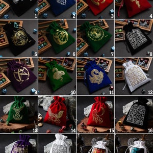 May include: Twenty different velvet and cotton drawstring bags with various designs and colors. Each bag has a different design, including a dragon, a snake, a tree, a pentagram, a skull, and a chest. The bags are perfect for storing dice, jewelry, or other small items.