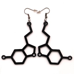 May include: A pair of black earrings shaped like the chemical structure of dopamine. The earrings are made of metal and have a simple, modern design.