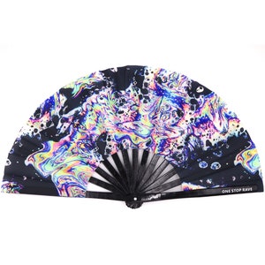 May include: A black hand fan with a vibrant, swirling pattern in shades of blue, purple, yellow, and pink. The fan's design includes black splatters and the text "ONE STOP RAVE" on the handle.