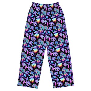 May include: Black trousers with a psychedelic print of colourful mushrooms. The mushrooms have rainbow colours and are on a black background.