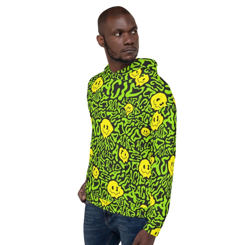 May include: A black hoodie with a green and yellow pattern of smiley faces. The hoodie has a drawstring hood and a kangaroo pocket.