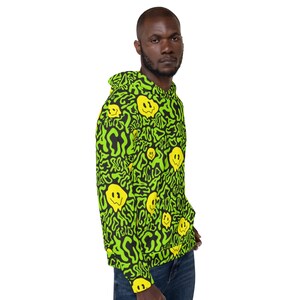 May include: A green and black hoodie with a repeating pattern of yellow smiley faces. The smiley faces are distorted and dripping, giving the design a psychedelic look.