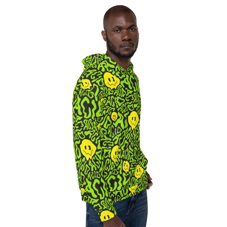 May include: A green and black hoodie with a repeating pattern of yellow smiley faces. The smiley faces are distorted and dripping, giving the design a psychedelic look.