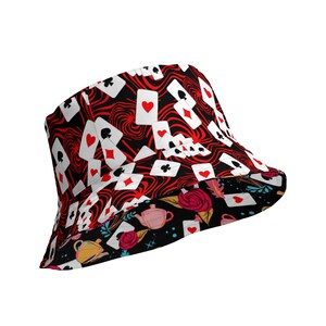 May include: A red and black bucket hat with a pattern of playing cards. The hat has a contrasting lining with a floral and teacup design.