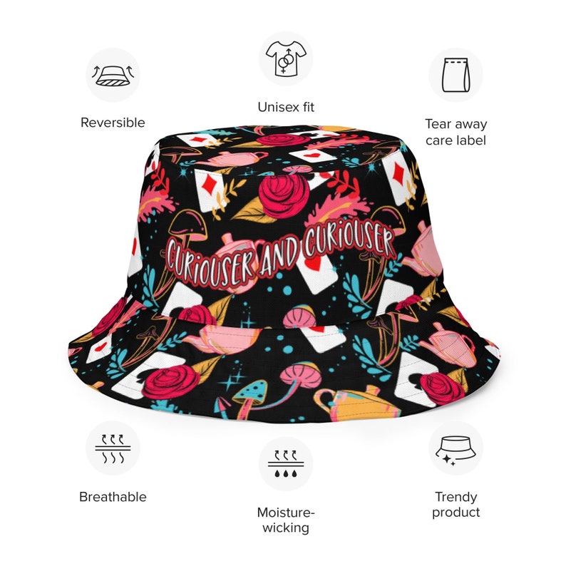 May include: A black bucket hat with a colorful print featuring playing cards, teacups, flowers, and mushrooms. The text "Curiouser and Curiouser" is printed on the hat.