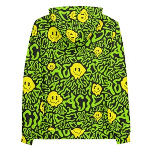May include: A black hoodie with a green and yellow pattern. The pattern features a repeating design of a smiley face with the word "acid" written in a wavy font.