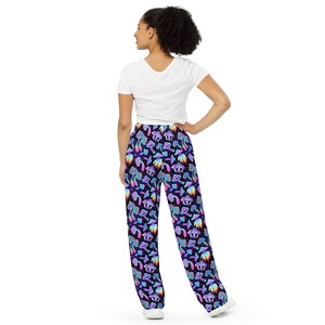 May include: A pair of black trousers with a colourful mushroom print. The trousers have a relaxed fit and a drawstring waist.