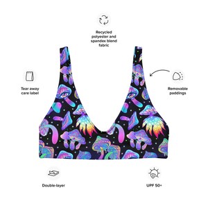 May include: A black bikini top with a colorful psychedelic mushroom pattern. The top is made of recycled polyester and spandex blend fabric, with removable paddings and a double-layer design. It also features UPF 50+ protection.