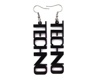 May include: A pair of black acrylic earrings with the word "TECHNO" written vertically on each earring.