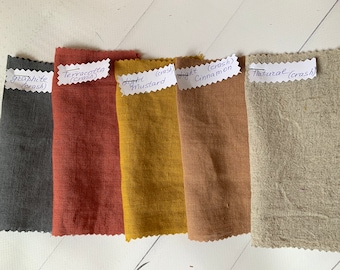 May include: Five fabric swatches in different colours and textures. The swatches are labelled with their colour and type of weave. The colours are graphite, terracotta, light mustard, light cinnamon, and natural.